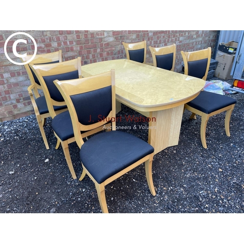 89 - A modern Italian style high gloss extending dining tabke together with a set of six chairs including... 