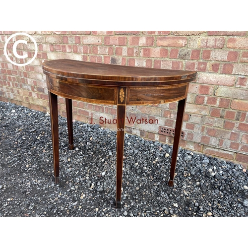 91 - A early Victorian mahogany Demi lune fold over card table