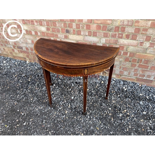 91 - A early Victorian mahogany Demi lune fold over card table