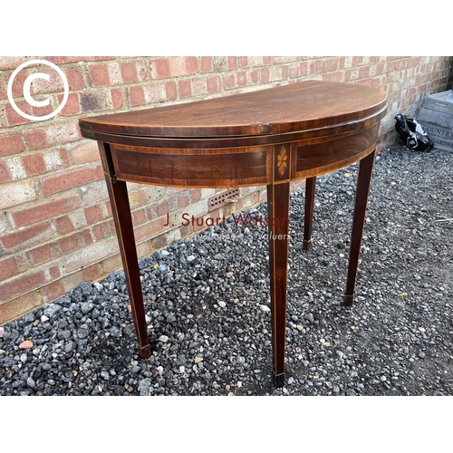 91 - A early Victorian mahogany Demi lune fold over card table