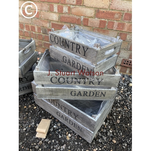 94 - Two graduated sets of three wooden country garden trug crates