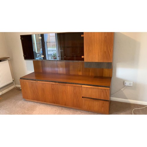 233 - A Macintosh teak sectional lounge unit with smoked glass front