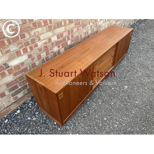 1 - A danish teak lowboy sideboard by Clausen & Son having four  central drawers flanked by sliding door... 