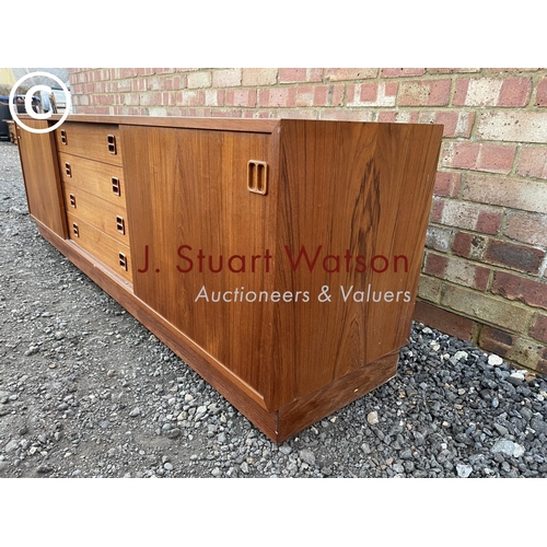 1 - A danish teak lowboy sideboard by Clausen & Son having four  central drawers flanked by sliding door... 