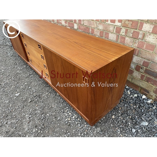 1 - A danish teak lowboy sideboard by Clausen & Son having four  central drawers flanked by sliding door... 