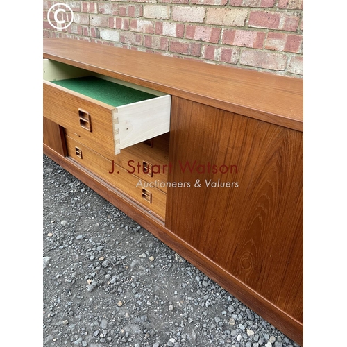 1 - A danish teak lowboy sideboard by Clausen & Son having four  central drawers flanked by sliding door... 