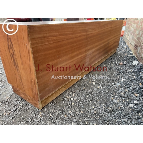 1 - A danish teak lowboy sideboard by Clausen & Son having four  central drawers flanked by sliding door... 