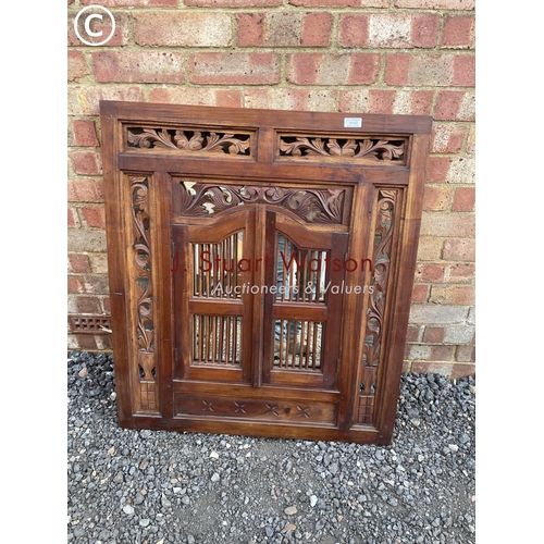 100 - An indonesian style carved hardwood shutter mirror