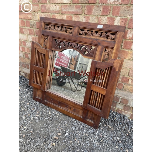 100 - An indonesian style carved hardwood shutter mirror