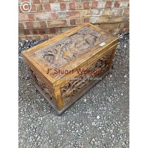 101 - A small hardwood box carved with elephant scenes