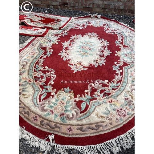 117 - A set of red pattern chinese carpets including very large oval