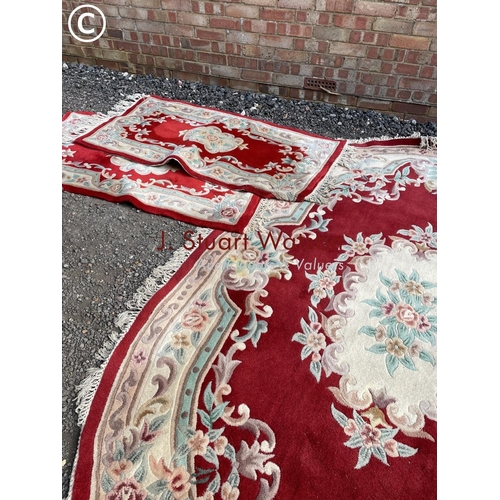 117 - A set of red pattern chinese carpets including very large oval