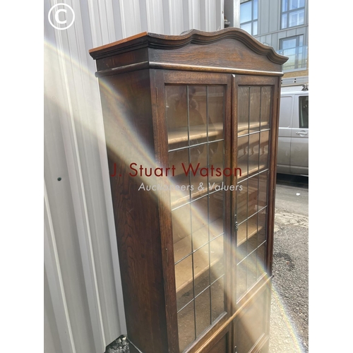 135 - An early 20th century oak bookcase with leaded glass doors