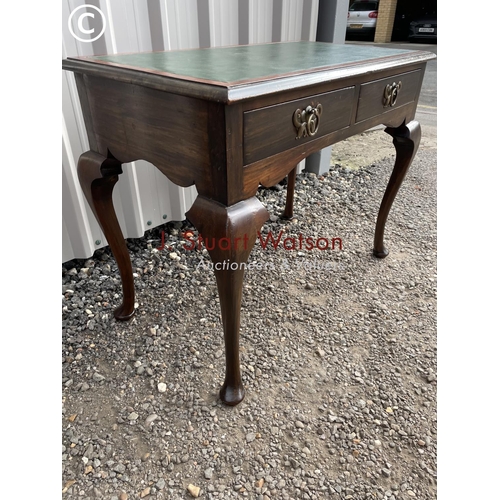 147 - A mahogany two drawer writing table with a green leather top