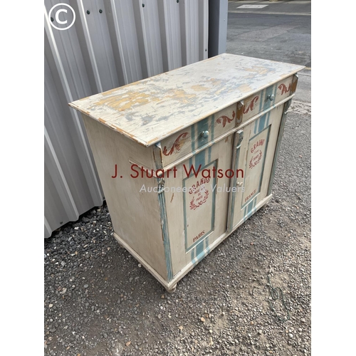 153 - A continental painted pine sideboard with two drawers over two cupboards