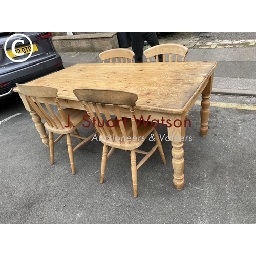 161 - A pine farmhouse table 180x96 together with four pine chairs