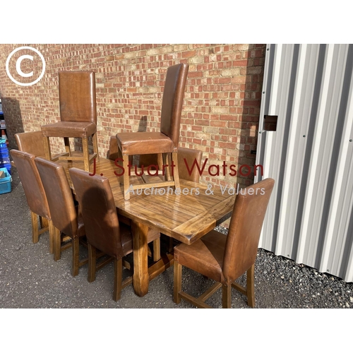 176 - A very large reproduction oak dining table together with a set of ten leather high back dining chair... 