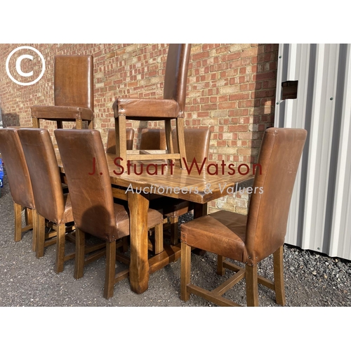 176 - A very large reproduction oak dining table together with a set of ten leather high back dining chair... 