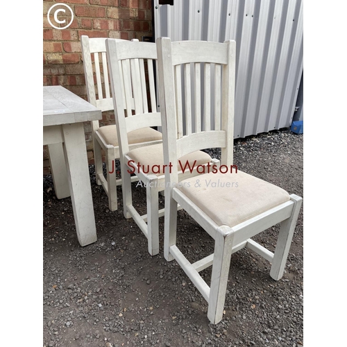 183 - A white painted farmhouse table with six chairs, two leaves