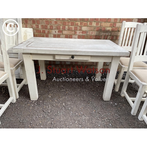 183 - A white painted farmhouse table with six chairs, two leaves