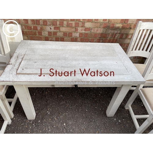 183 - A white painted farmhouse table with six chairs, two leaves