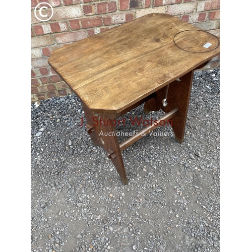 214 - A 20th century oak arts and crafts occasional table 70x48x76