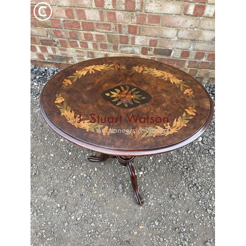 215 - A Victorian mahogany snap top occasional table inlaid with floral patterns to the top