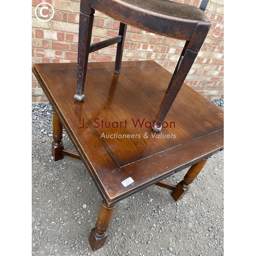 224 - Two early 20th century oak drawer leaf tables together with two chairs