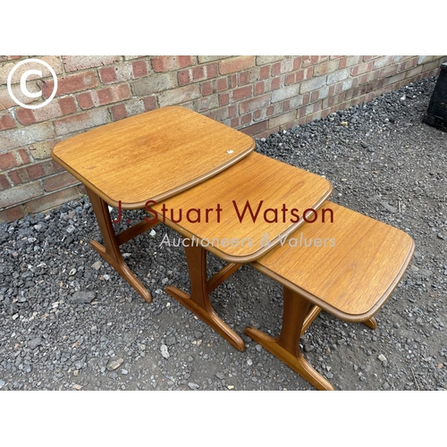 230 - A mid century teak nest of three tables