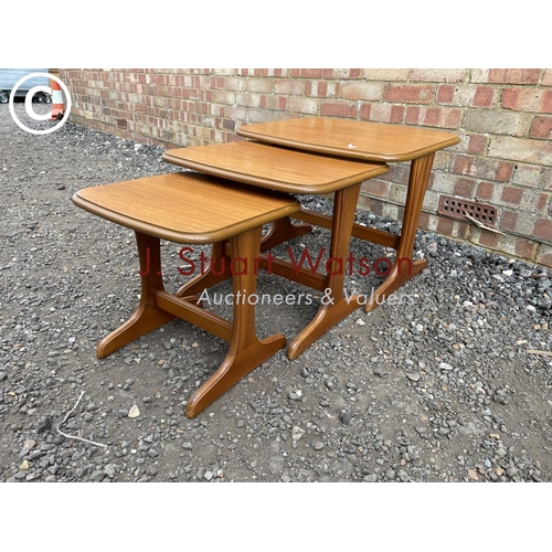 230 - A mid century teak nest of three tables