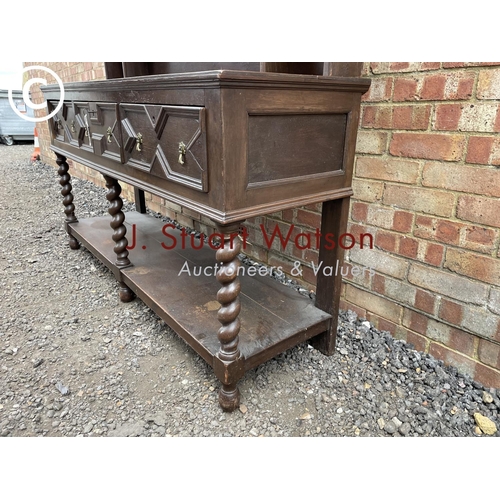 231 - An antique barley twist oak dresser with a plate rack back over three drawer base