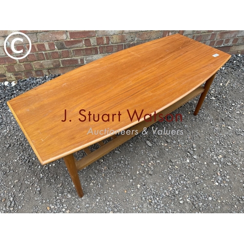 233 - A mid century teak coffee table with a slatted under tier