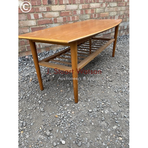 233 - A mid century teak coffee table with a slatted under tier