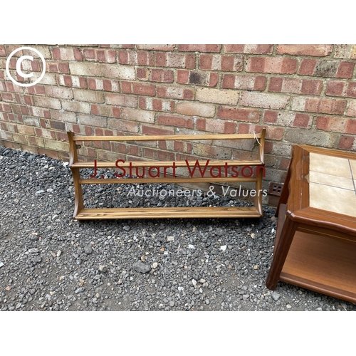 241 - A teak tile top coffee table together with an Ercol plate rack