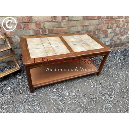 241 - A teak tile top coffee table together with an Ercol plate rack