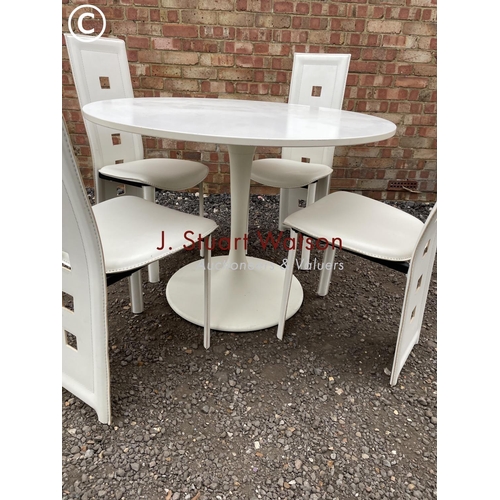 243 - A modern Arkana style white circular table together with four high back chairs