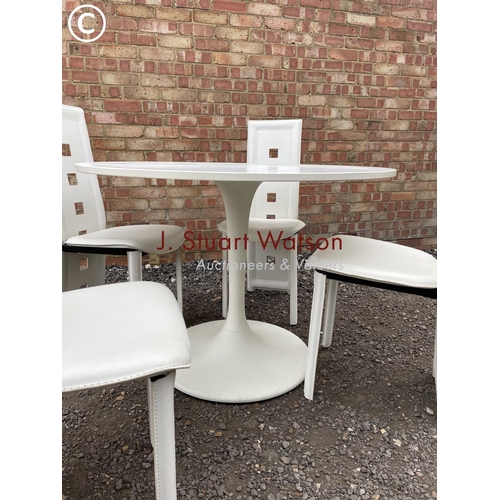 243 - A modern Arkana style white circular table together with four high back chairs