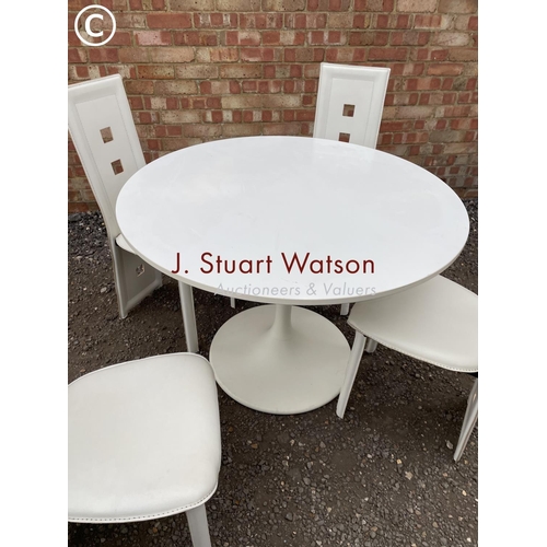 243 - A modern Arkana style white circular table together with four high back chairs