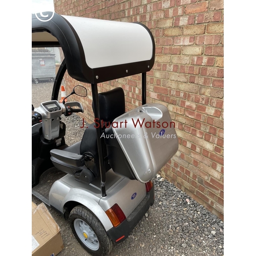 247 - A TGA Mobility scooter with canopy top cover, additional wet weather side cover, keys and charger in... 