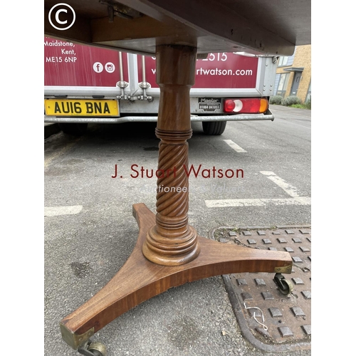 272 - A circular oak tilt top table with brass inlay