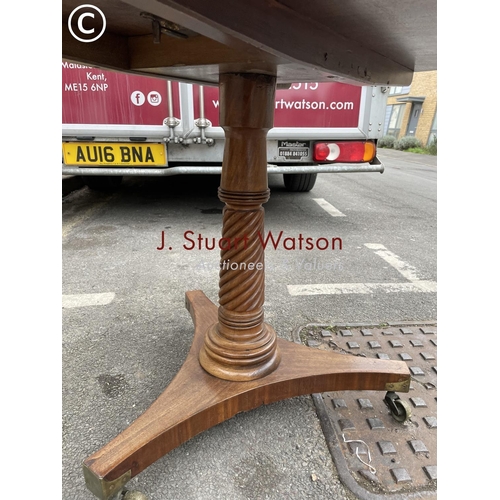 272 - A circular oak tilt top table with brass inlay