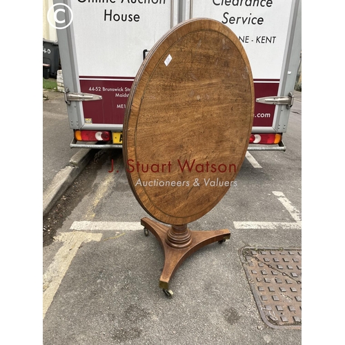 272 - A circular oak tilt top table with brass inlay