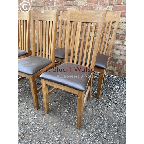 29 - A set of six modern light oak dining chairs