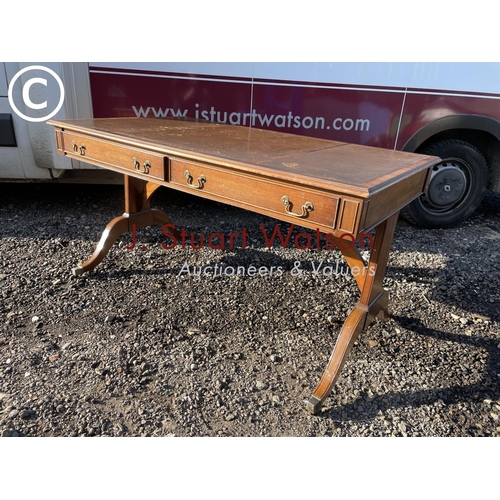 302 - A reproduction mahogany leather writing table with two drawers and two dummy drawers fitted with bro... 