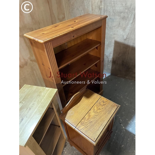 326 - A pine opem fronted bookcase together with a light oak bookcase and an oak bedside