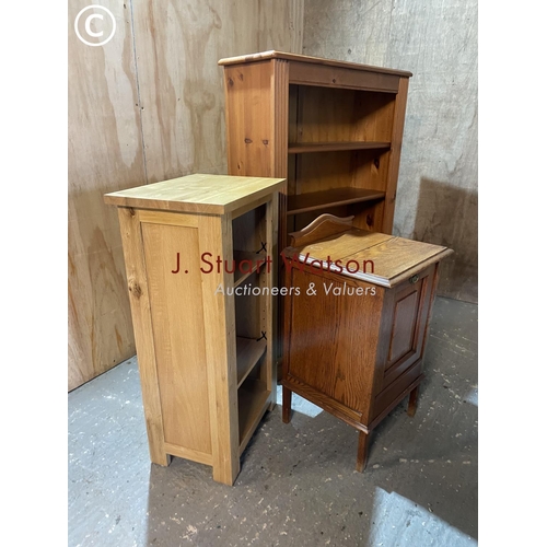 326 - A pine opem fronted bookcase together with a light oak bookcase and an oak bedside