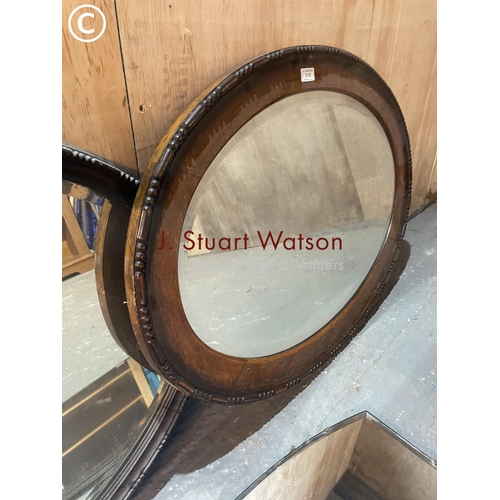 350 - Two oval oak framed mirrors together with a frameless mirror