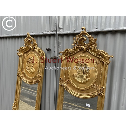 409 - A pair of highly or ornate  gold gilt hallway mirrors decorated with a lady and a gent each 180x48