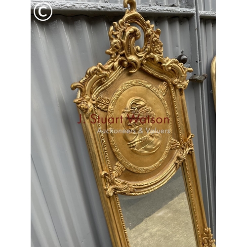 409 - A pair of highly or ornate  gold gilt hallway mirrors decorated with a lady and a gent each 180x48