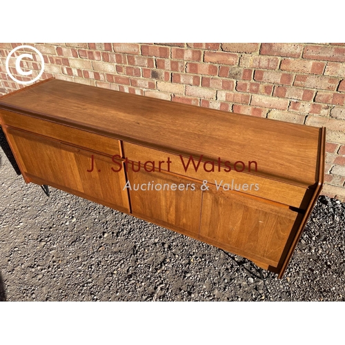 48 - A mid century teak sideboard with two drawers over four cupboard doors raised on hairpin legs